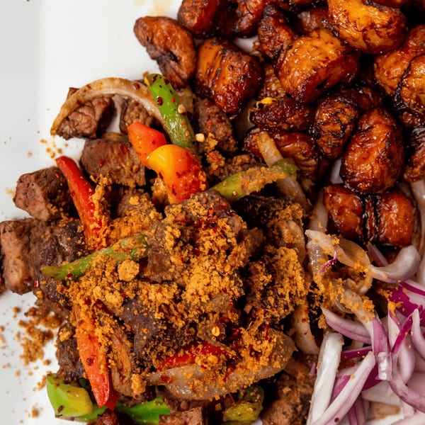 Azara Kitchen's African dish with meat, peppers, onions, and fried plantains.
